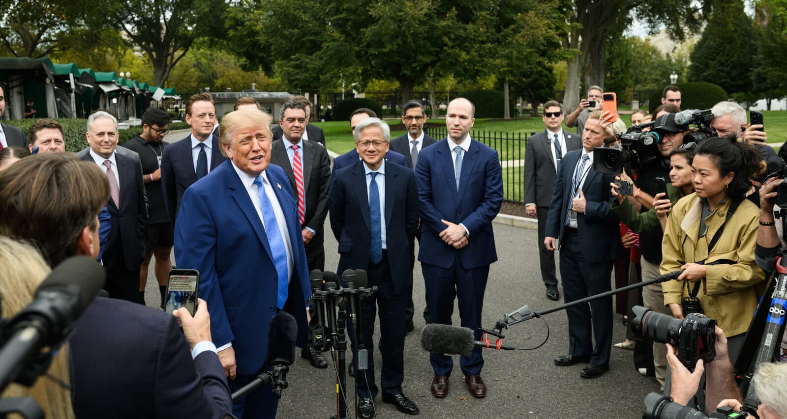 Donald Trump speaks to the press outside the West Wing, with tech executives behind him, after the lunch on September 29, 2026.